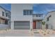 Modern two-story home with a gray garage door and desert landscaping at 10448 Smokey Mariposa, Las Vegas, NV 89166