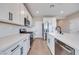 Stylish kitchen with white cabinetry, stainless steel appliances, and modern black hardware at 10448 Smokey Mariposa, Las Vegas, NV 89166