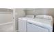 Laundry room with white washer and dryer and access to walk-in closet at 10448 Smokey Mariposa, Las Vegas, NV 89166