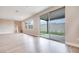 Open concept living area featuring wood-look floors and a sliding glass door to backyard at 10448 Smokey Mariposa, Las Vegas, NV 89166