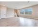 Spacious living room with large windows and wood-look floors at 10448 Smokey Mariposa, Las Vegas, NV 89166