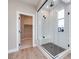 Modern bathroom with glass enclosed shower and walk-in closet at 10448 Smokey Mariposa, Las Vegas, NV 89166