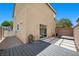 Enclosed backyard featuring a patio deck and a combination of paving stones and gravel at 106 Basketflower Ct, Las Vegas, NV 89183