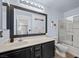 This bathroom features a well-lit mirror, white sink, and a glass door shower at 106 Basketflower Ct, Las Vegas, NV 89183