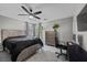 Comfortable bedroom features a large window, a ceiling fan, and neutral paint at 106 Basketflower Ct, Las Vegas, NV 89183