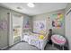 This charming bedroom is decorated with bright colors and whimsical decor, and has a view to the outdoors at 106 Basketflower Ct, Las Vegas, NV 89183
