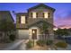 Charming two-story home features desert landscaping, a covered porch, and a two car garage at 106 Basketflower Ct, Las Vegas, NV 89183