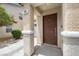 View of the front entrance showcasing the neutral-toned exterior with a simple, paneled front door at 106 Basketflower Ct, Las Vegas, NV 89183
