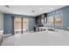 Modern kitchen with stainless steel appliances, white countertops, and tile flooring at 106 Basketflower Ct, Las Vegas, NV 89183