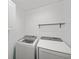 A well-lit laundry room features a modern washer and dryer set for convenient laundry care at 106 Basketflower Ct, Las Vegas, NV 89183