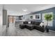 Open-concept living area with neutral paint, wood-look tile flooring, and lots of natural light at 106 Basketflower Ct, Las Vegas, NV 89183