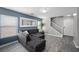 Bright living area features neutral paint, wood-look tile flooring, and a staircase at 106 Basketflower Ct, Las Vegas, NV 89183