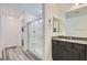 Modern bathroom featuring a glass-enclosed shower and a granite countertop vanity at 10650 Sariah Skye Ave, Las Vegas, NV 89166