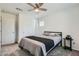 Comfortable bedroom with a ceiling fan, closet, and soft gray carpet at 10650 Sariah Skye Ave, Las Vegas, NV 89166