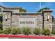 Stone sign reading RAVENNA with manicured landscaping in a welcoming community entrance at 10650 Sariah Skye Ave, Las Vegas, NV 89166