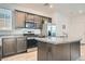 Well-lit kitchen featuring stainless steel appliances and an island with granite countertops at 10650 Sariah Skye Ave, Las Vegas, NV 89166