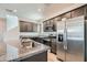 Modern kitchen featuring stainless steel appliances and granite countertops at 10650 Sariah Skye Ave, Las Vegas, NV 89166