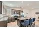 Bright kitchen with gray cabinets, stainless steel appliances, and granite island with seating at 10650 Sariah Skye Ave, Las Vegas, NV 89166