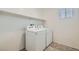 Bright laundry room features a white washer and dryer set and a shelf for storage at 10650 Sariah Skye Ave, Las Vegas, NV 89166