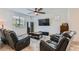 Cozy living room with comfortable seating and a large television at 10650 Sariah Skye Ave, Las Vegas, NV 89166