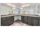 Bright main bathroom with double vanity, granite countertop and ample mirror space at 10650 Sariah Skye Ave, Las Vegas, NV 89166