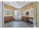 A stunning bathroom with double vanities, unique lighting fixtures, and a stylish soaking tub at 10814 Franklin Hills Ave, Las Vegas, NV 89135