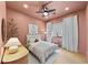 Comfortable bedroom featuring a ceiling fan, recessed lights, hardwood floors, and white curtains at 10814 Franklin Hills Ave, Las Vegas, NV 89135