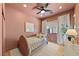 Cozy bedroom with pink walls, recessed lighting, wood floors, and white curtains at 10814 Franklin Hills Ave, Las Vegas, NV 89135
