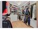 Walk-in closet featuring custom shelving, ample storage space, and a stylish chandelier at 10814 Franklin Hills Ave, Las Vegas, NV 89135
