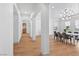 Open-concept dining room featuring wood floors and a modern chandelier, creating an inviting atmosphere at 10814 Franklin Hills Ave, Las Vegas, NV 89135