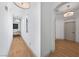 Bright hallway with hardwood floors, white walls, and modern lighting fixtures at 10814 Franklin Hills Ave, Las Vegas, NV 89135