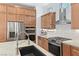Bright kitchen features an island sink, stainless steel appliances, light wood cabinets and tile backsplash at 10814 Franklin Hills Ave, Las Vegas, NV 89135