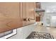 Close up on the natural wood cabinets with gold hardware and light countertops at 10814 Franklin Hills Ave, Las Vegas, NV 89135