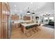 Spacious kitchen featuring wood floors, an island with bar stools, and open access to the living area at 10814 Franklin Hills Ave, Las Vegas, NV 89135