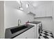 Bright laundry room featuring granite counters, sleek cabinetry, and modern washer and dryer at 10814 Franklin Hills Ave, Las Vegas, NV 89135