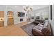 Spacious living room with a stone fireplace, built in shelving and large sectional sofa at 10814 Franklin Hills Ave, Las Vegas, NV 89135