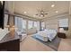 Spacious main bedroom with a ceiling fan, recessed lights, windows, and an elegant sitting area at 10814 Franklin Hills Ave, Las Vegas, NV 89135