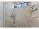 Modern shower with large marble-style tiling, glass door, and niche at 10814 Franklin Hills Ave, Las Vegas, NV 89135