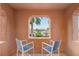 Charming balcony with seating offers a peaceful view of the neighborhood and palm trees at 11271 Winter Cottage Pl, Las Vegas, NV 89135