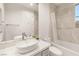 Modern bathroom features sleek vanity, shower over tub, and light tile at 11271 Winter Cottage Pl, Las Vegas, NV 89135