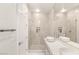 Bathroom featuring double sinks with white countertops, and modern glass enclosed shower with white tile at 11271 Winter Cottage Pl, Las Vegas, NV 89135