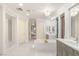 Open bathroom featuring an elegant soaking tub, a chandelier and plenty of natural light at 11271 Winter Cottage Pl, Las Vegas, NV 89135