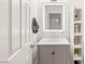Bathroom featuring a modern sink, well lit mirror and white shelf at 11271 Winter Cottage Pl, Las Vegas, NV 89135
