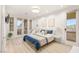 Well-lit bedroom with bed, light blue accents and balcony doors that let in light at 11271 Winter Cottage Pl, Las Vegas, NV 89135