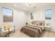 Bright bedroom with natural light features a modern bed, chair and windows at 11271 Winter Cottage Pl, Las Vegas, NV 89135