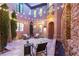 Charming courtyard featuring a stone water feature, stone floors and outdoor seating at 11271 Winter Cottage Pl, Las Vegas, NV 89135