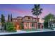 Elegant two-story home boasting mature palm trees and a well-manicured lawn at 11271 Winter Cottage Pl, Las Vegas, NV 89135