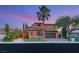 Elegant two-story home boasting mature palm trees and a well-manicured lawn at 11271 Winter Cottage Pl, Las Vegas, NV 89135