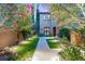 Inviting front entrance with walkway, manicured lawn, and vibrant greenery at 11271 Winter Cottage Pl, Las Vegas, NV 89135