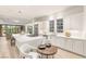 Open concept kitchen featuring white cabinets, large island with seating, and stainless steel appliances at 11271 Winter Cottage Pl, Las Vegas, NV 89135